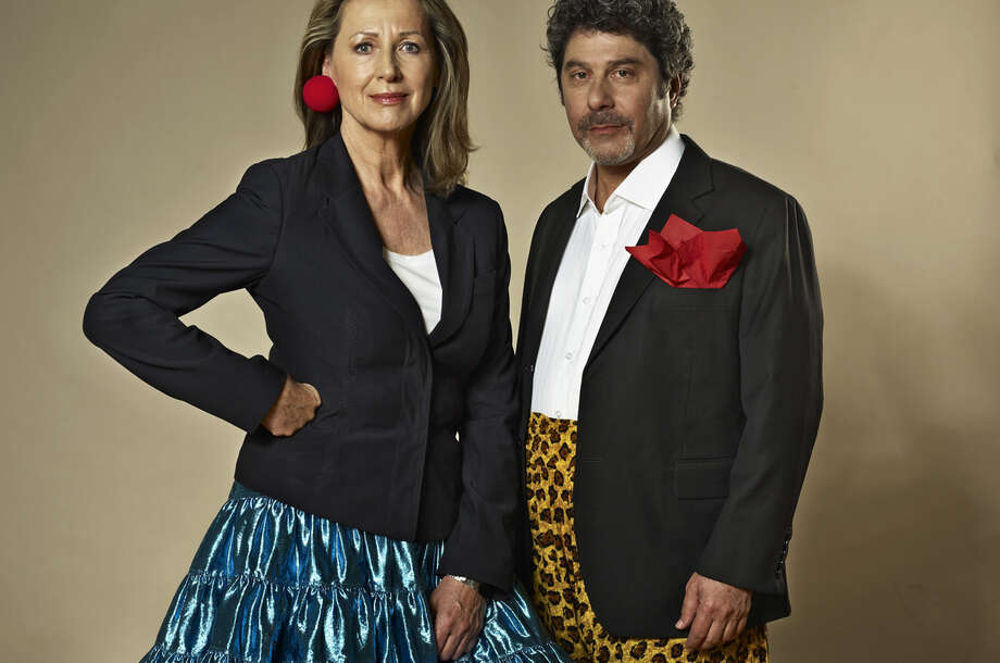 RED NOSES International founders Monica Culen, CEO, and Giora Seeliger, Artistic Director, stand next to each other in colourful outfits.