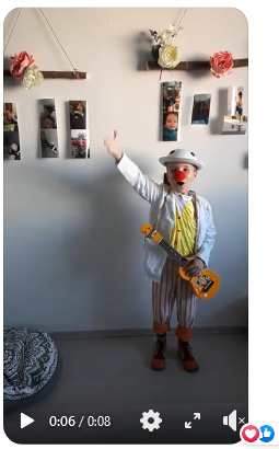 Leo, after his online performance thanking his fans for their reaction to his video. Dressed as a clown and holding the ukulele.
